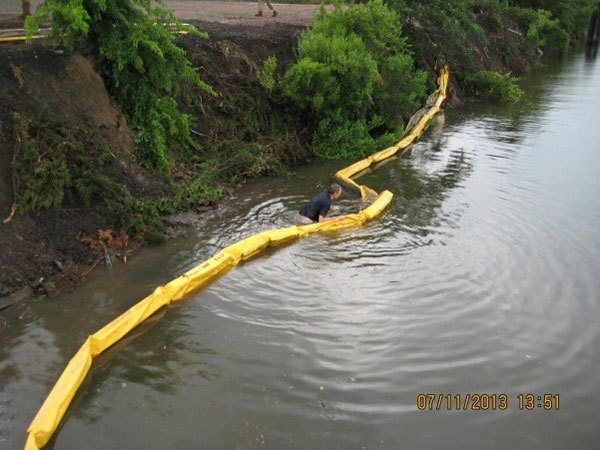 workers deploying the turbidity curtain by hand